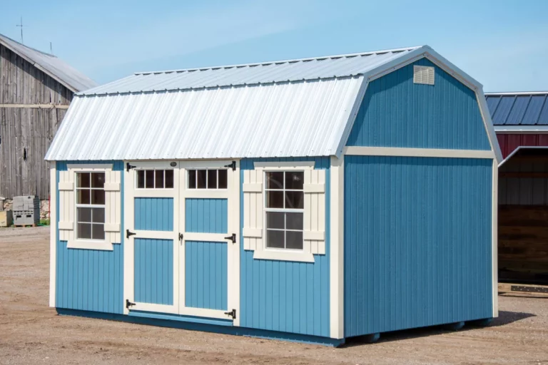 Lofted garden shed for saw in Rockford Michigan - Blue storage shed with white trim, shutters, and double doors with windows.