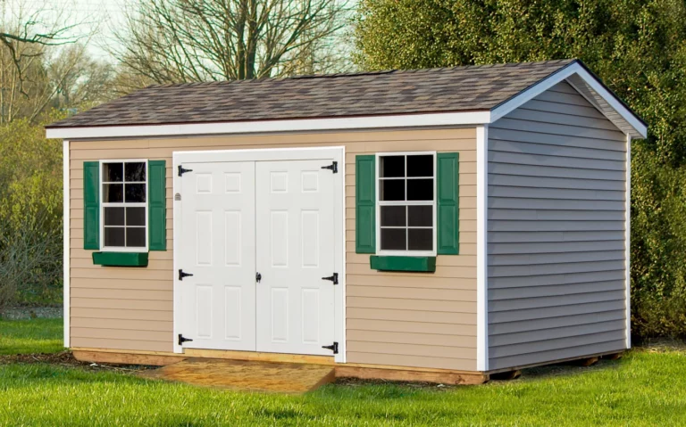 Beige vinyl garden shed in Sears with green shutters and asphalt roof.