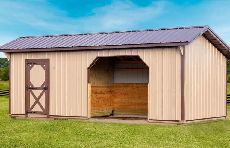 Red mini animal shelter with a white roof and open front, set on a grassy field.